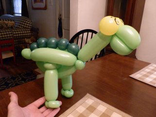 green dinosaur balloon animal